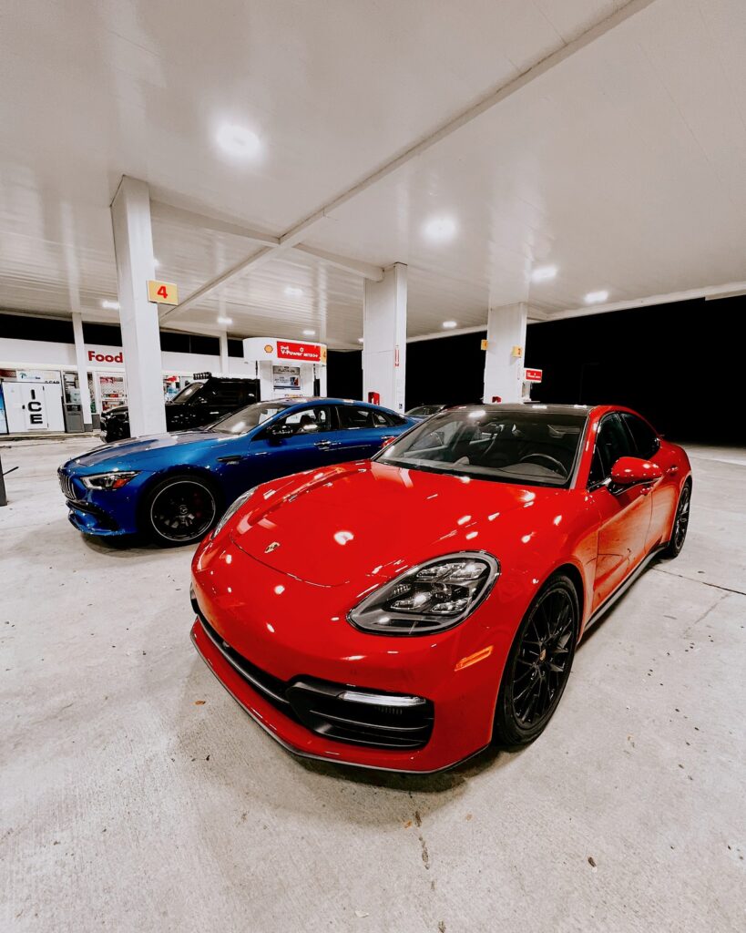 Red Porsche Panamera and Mercedes-AMG GT at gas station in Fort Lauderdale — Turtur Luxury Cars
